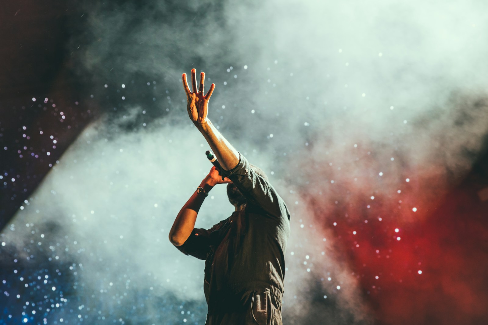Musician silhouetted on a smoke-filled concert stage