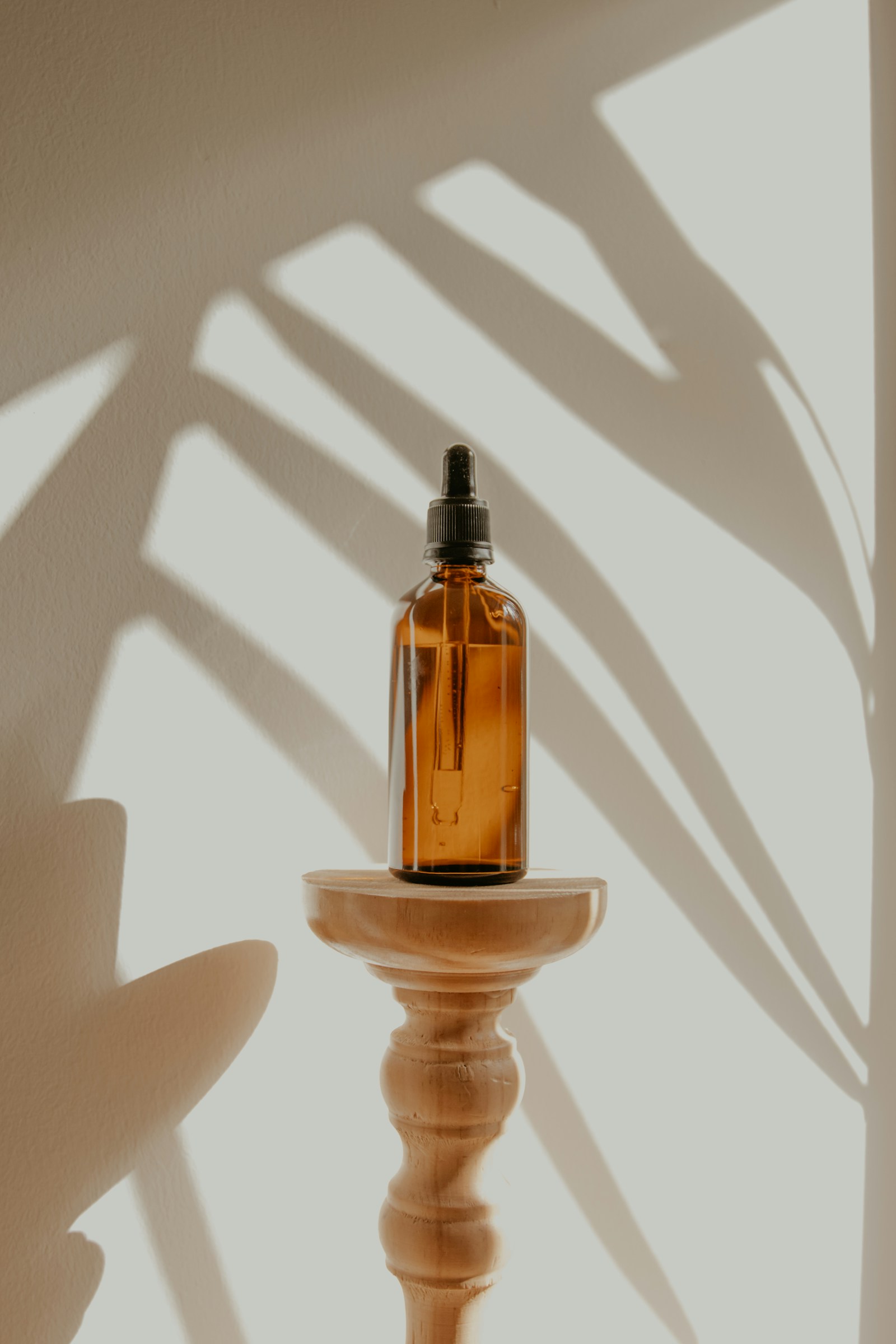 Skincare bottles and natural ingredients arranged on a warm surface